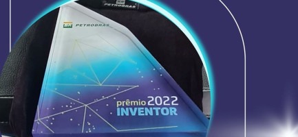 Imagem do troféu em acrílico que tem formato triangular em cores degradê do azul escuro ao branco e com as inscrições: Petrobras: Prêmio Inventor 2022. Fim da descrição.